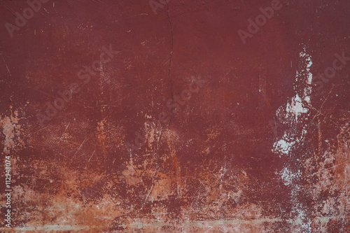 old wall with peeling paint, scratched stained plaster - grunge background of urban decay