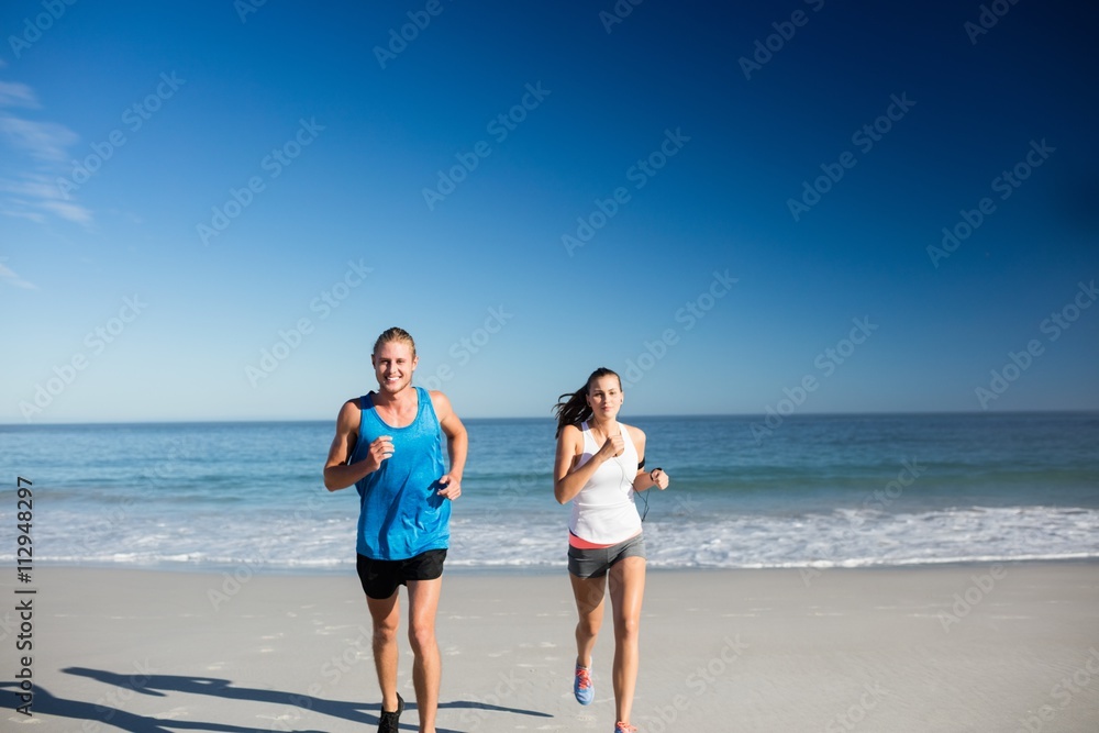 Friends jogging at the beach