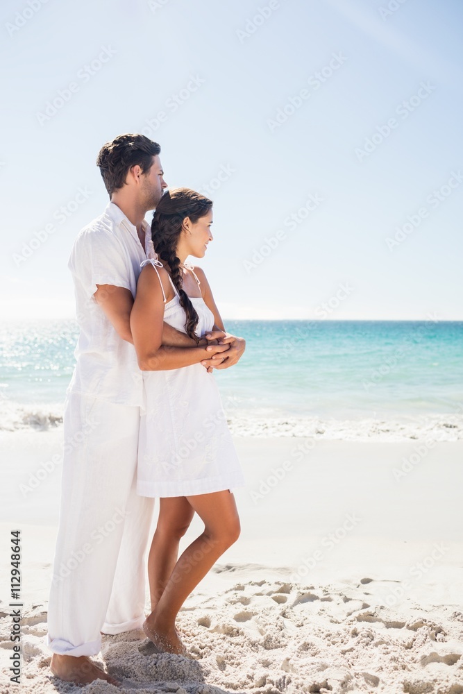  Happy couple embracing on the beach