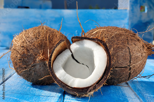 Cloven coconut on a blue wooden background