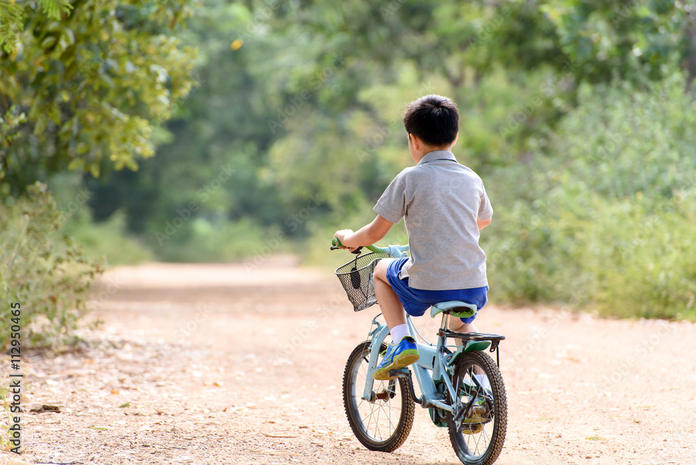 Boy riding bicycle on the road. Boy riding bicycle on the road.