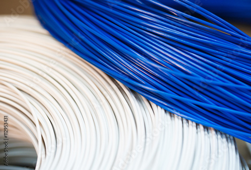close up a roll of white and blue cable