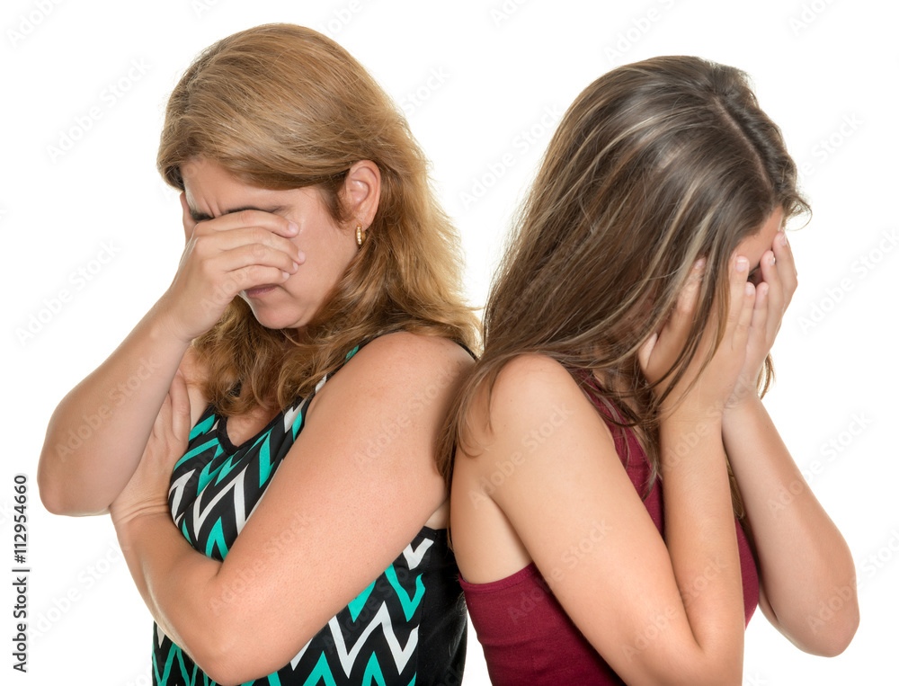 Mother and her teenage daughter both crying Mother and her teenage daughter both crying