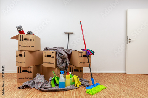 Sauberer, weißer Raum mit Kartons und Putzzeug