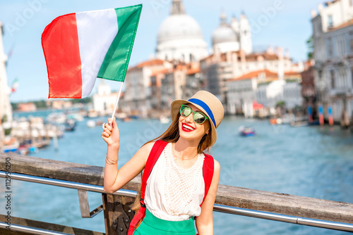 Bild auf Leinwand Young female traveler with italian flag on the bridge with geat view on Grand ca