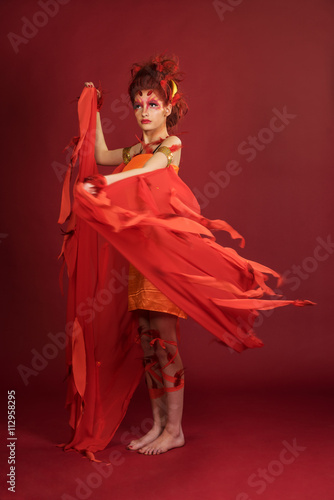Phoenix woman. Flaming young girl on the red background