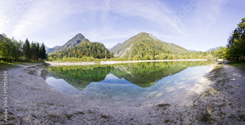 Crystal clear blue water, lake and mountains. Panorama of wild landscape, natural environment. Julian Alps, Triglav National Park in Slovenia.