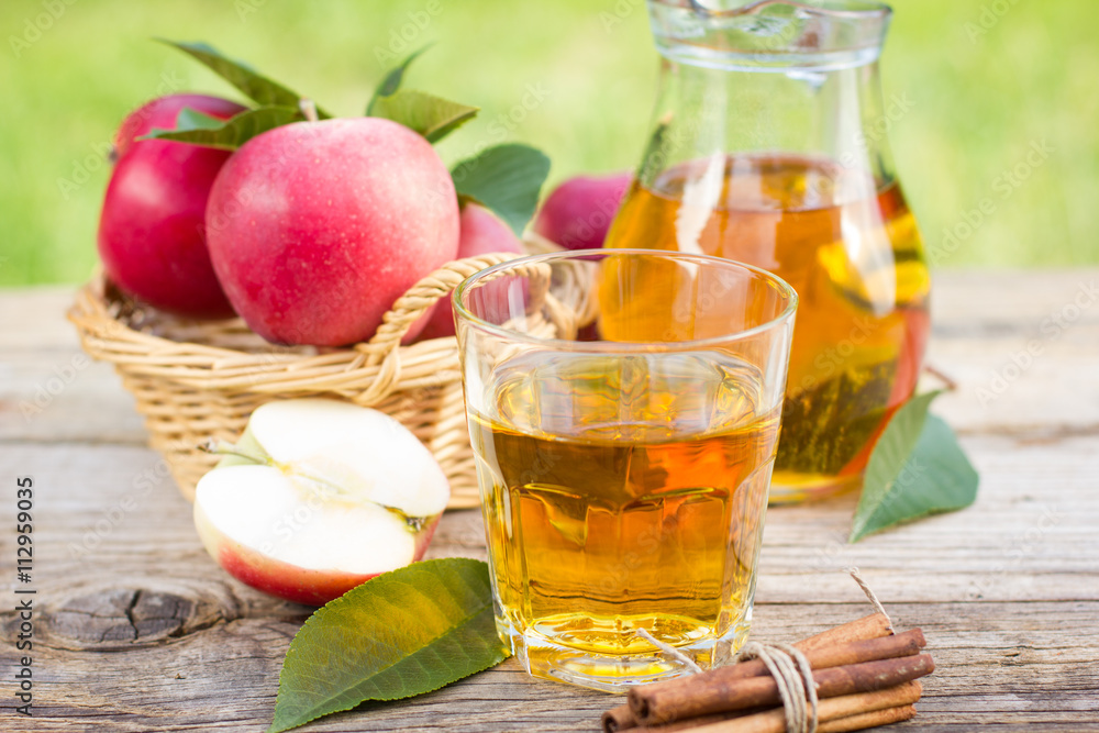 Apple juice in the glass and pitcher Apple juice in the glass and pitcher
