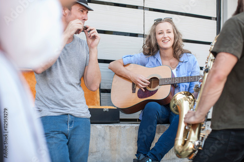 Three street musicians playing together