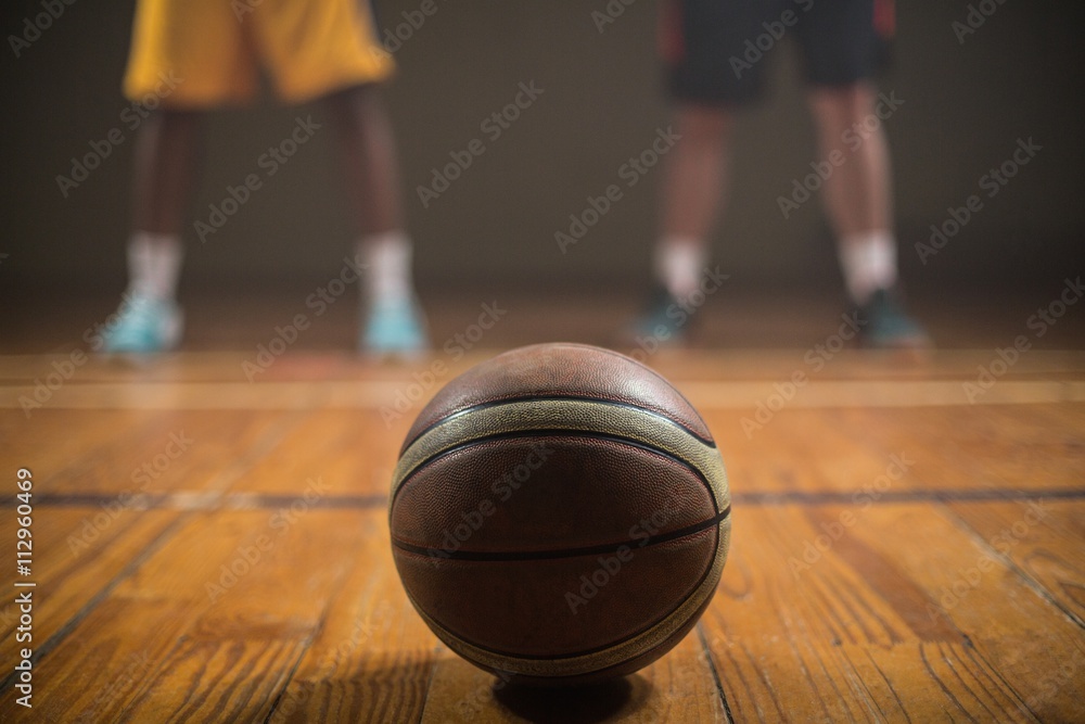 Naklejka premium Close up on basketball putting on the floor 