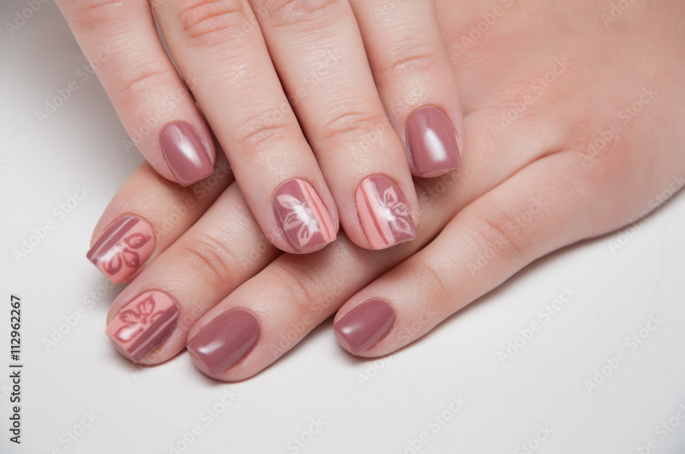 beige manicure on a white background with short nails with flowers beige manicure on a white background with short nails with flowers