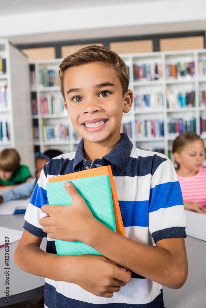 Little boy standing with notebooks Little boy standing with notebooks