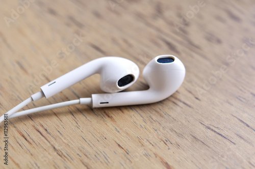 Digital Music White Headphones On Wood Table