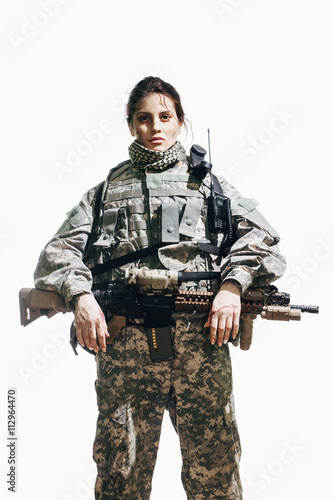 Portrait of female soldier standing with rifle against white background photo