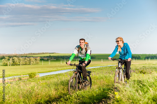 couple cycling outdoors