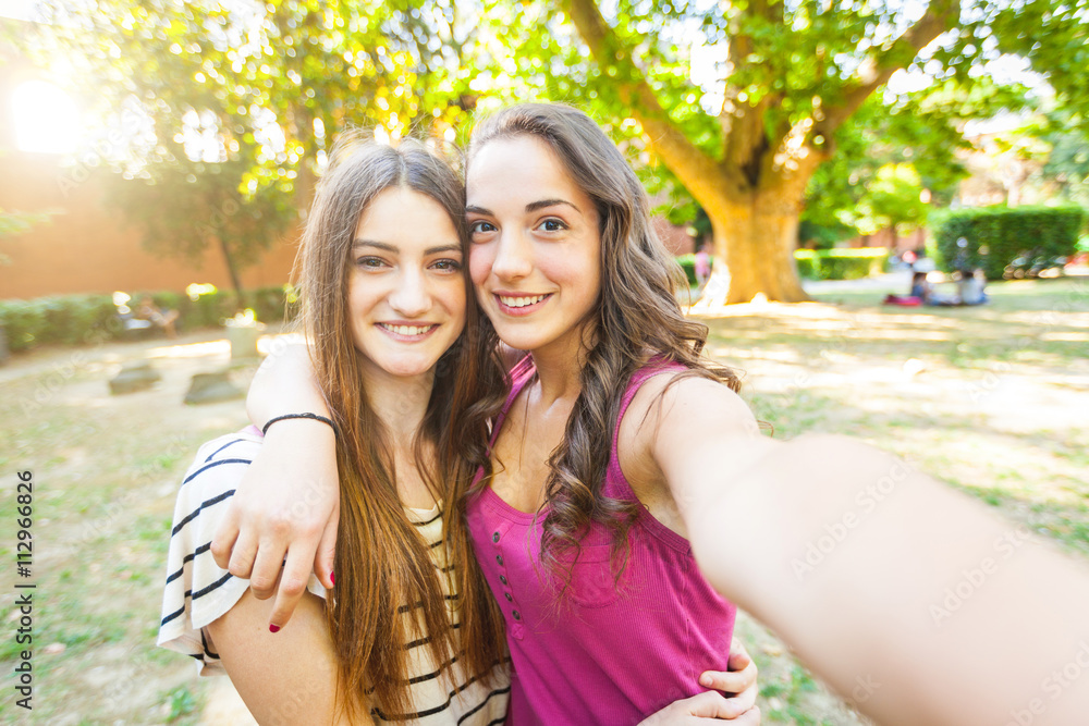 Two girls taking a selfie together at park