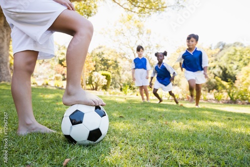 Children wearing soccer uniform playing a match