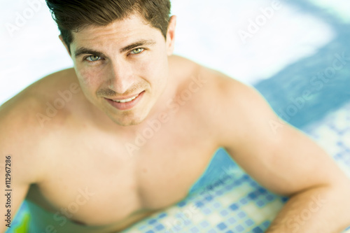 Young man relaxing in the pool
