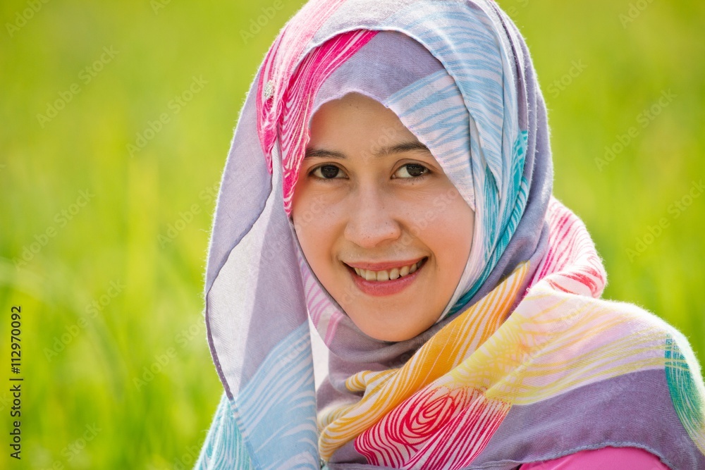 Muslim woman playing on paddy field in a village at Indonesia Muslim woman playing on paddy field in a village at Indonesia