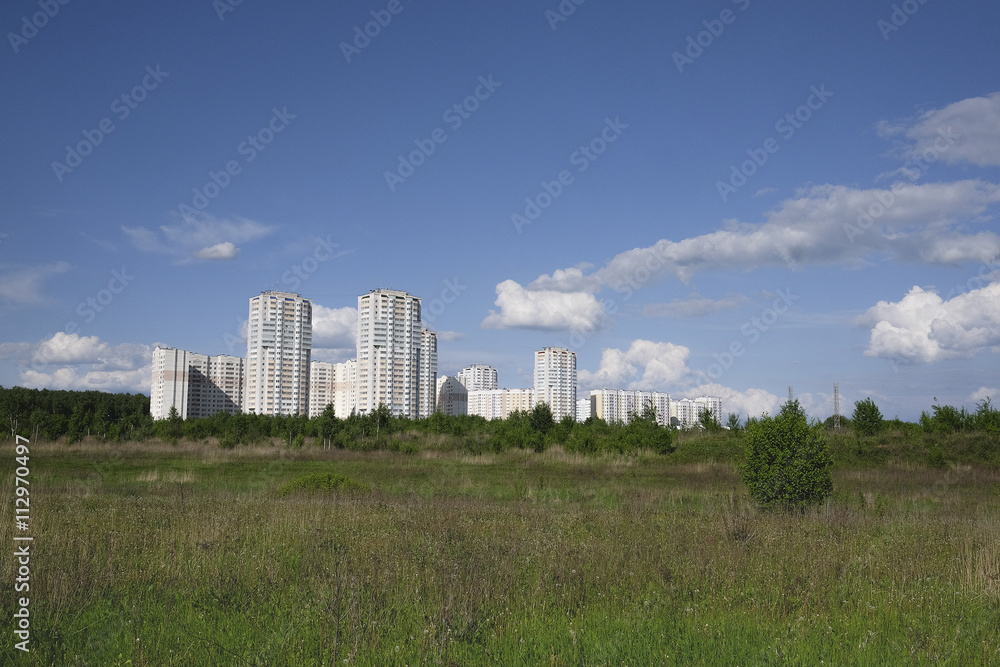Landscape with the image of field and modern houses