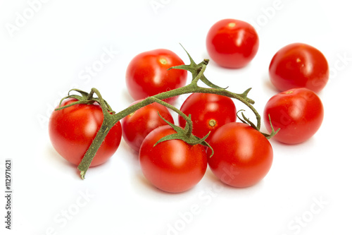 The branch of cherry tomatoes on white