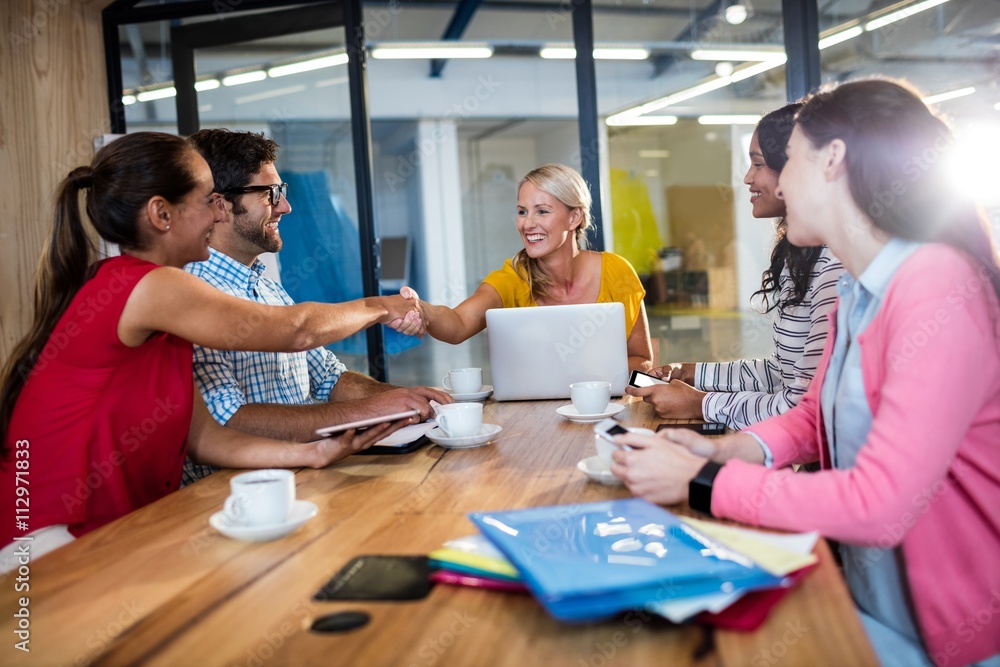Casual business team giving handshake Casual business team giving handshake