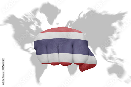 Photography fist with the national flag of thailand on a world map background