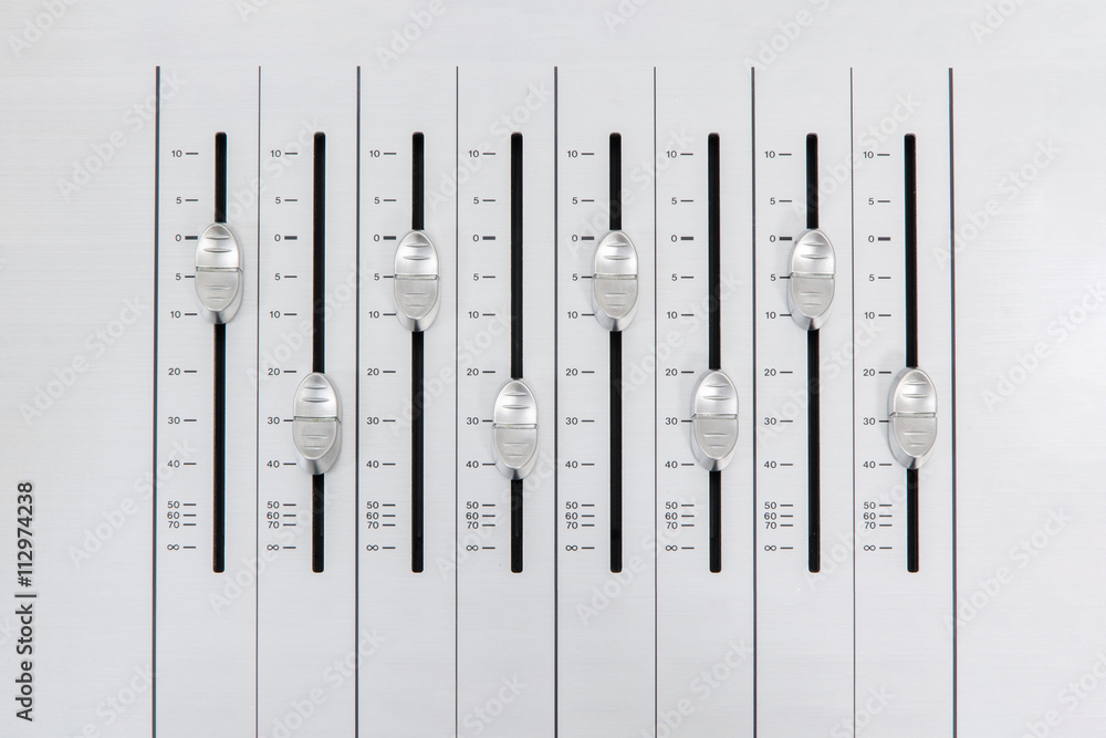 music mixer slider buttons on metallic casing forming an alternate pattern with small amplitude