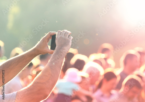 Shooting photos with a mobile phone in a crowd