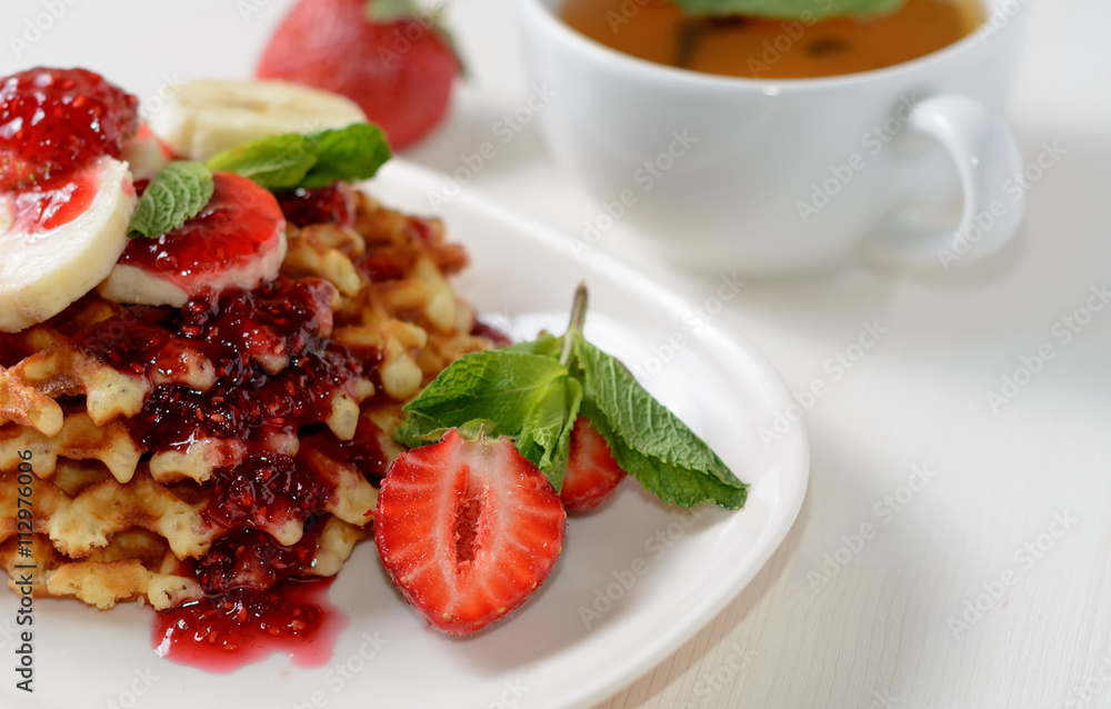belgium waffles with strawberries, mint and raspberry jam belgium waffles with strawberries, mint and raspberry jam