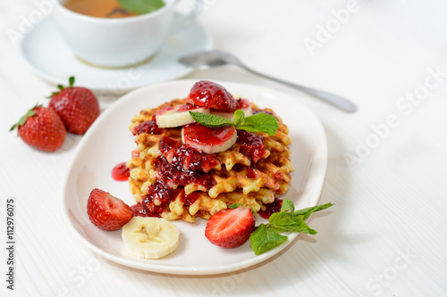 belgium waffles with strawberries, mint and raspberry jam