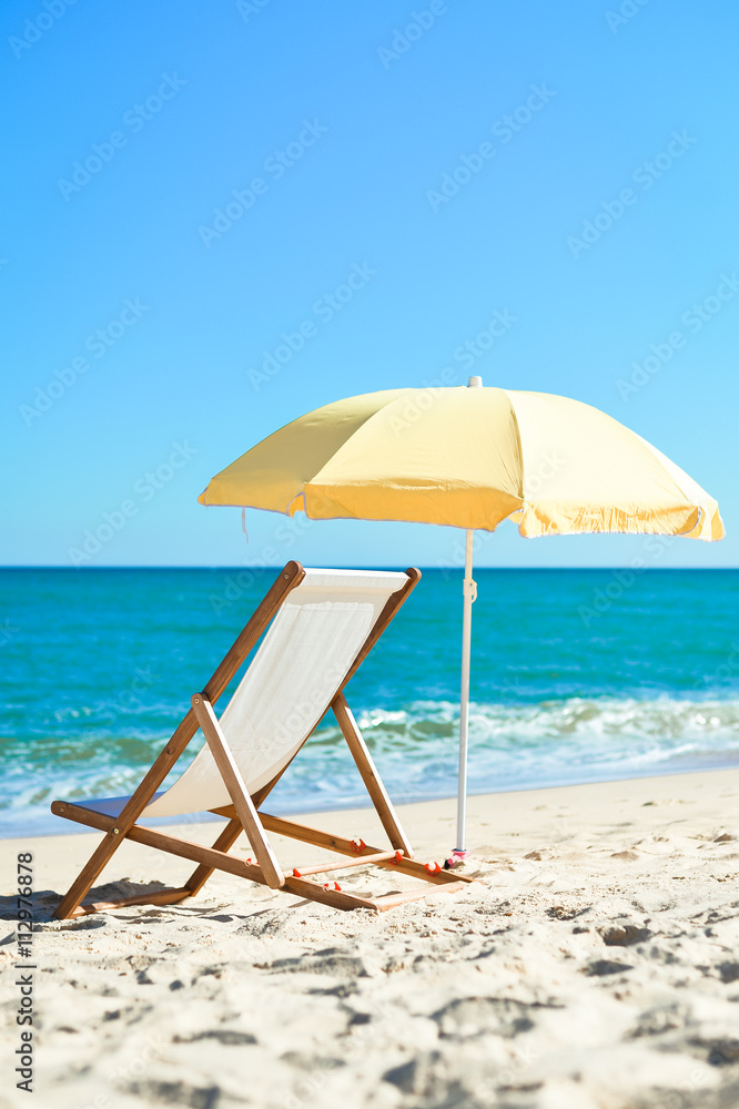 Back View Of Deckchair, Sun Lounger Under Umbrella On Sand Beach. Back View Of Deckchair, Sun Lounger Under Umbrella On Sand Beach.