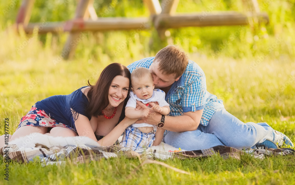 Happy family having fun outdoors in spring field. Summer photo.Blurred background. Happy family having fun outdoors in spring field. Summer photo.Blurred background.