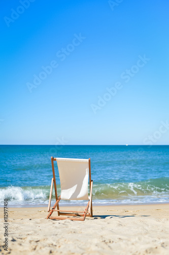 Fototapeta Naklejka Na Ścianę i Meble -  Beautiful beach landscape with chair for relaxation. Travel background