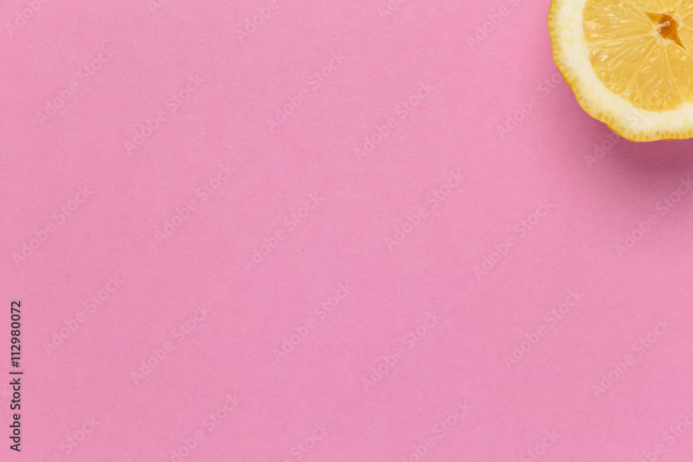 Part of juicy lemon menu poster on pink background. Top view of juicy lemon  on a colorful background. Slice of bright lemon in the top right corner of  the image. Stock Photo |