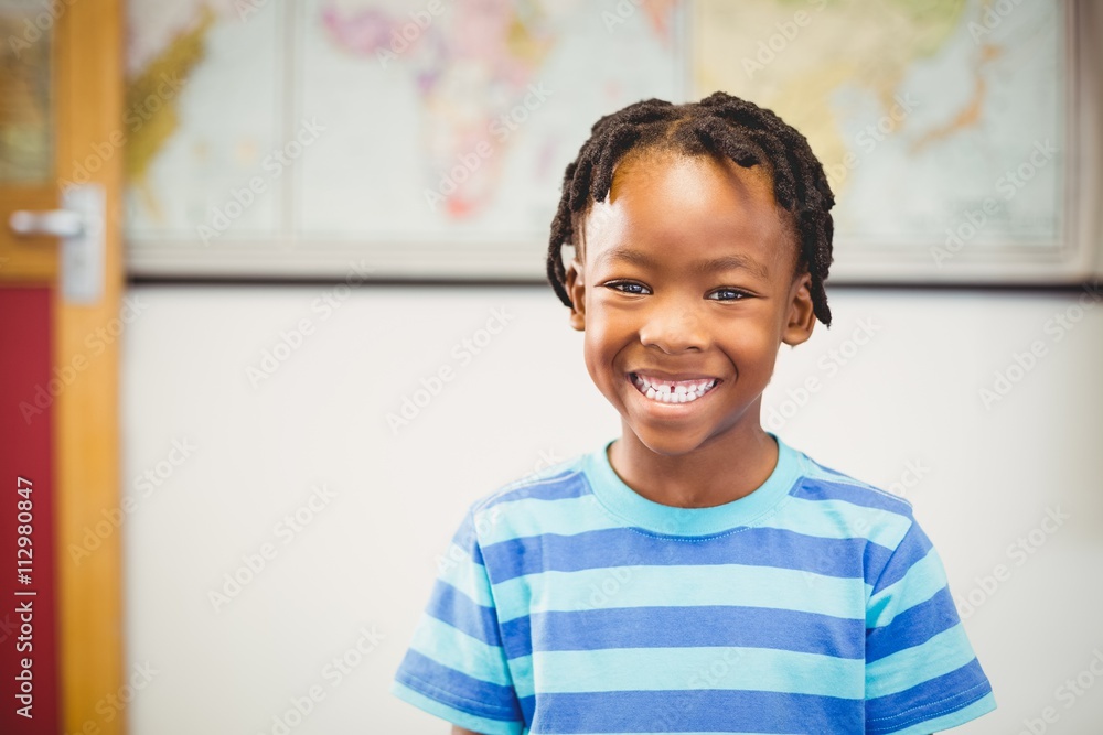 Fototapeta premium Portrait of smiling schoolboy in classroom
