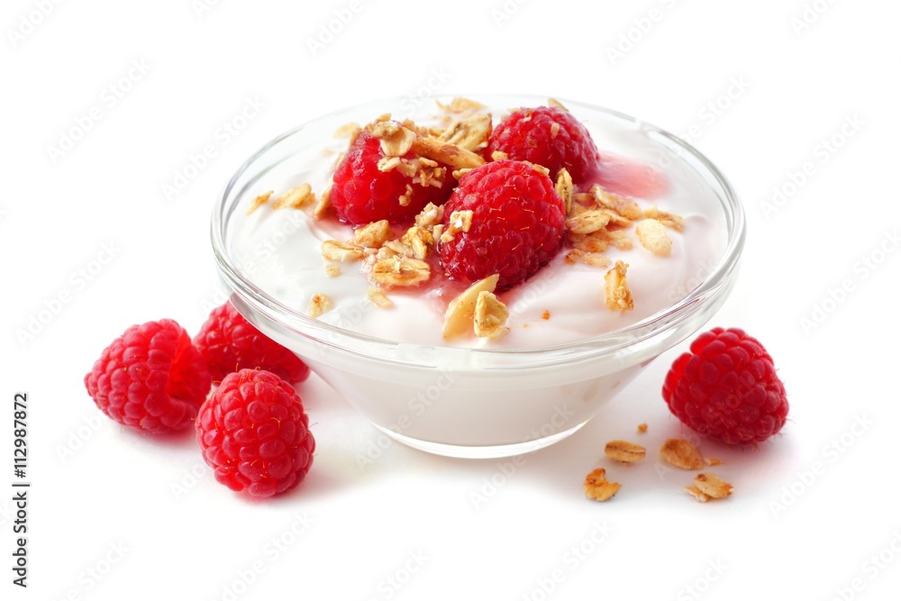 Clear bowl of raspberry flavored yogurt with granola and berries over a white background Clear bowl of raspberry flavored yogurt with granola and berries over a white background