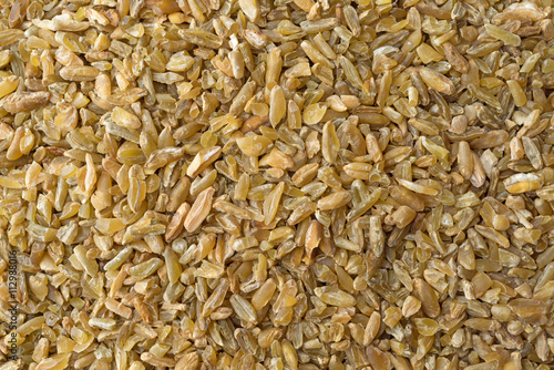 Close view of cracked freekeh grain. photo