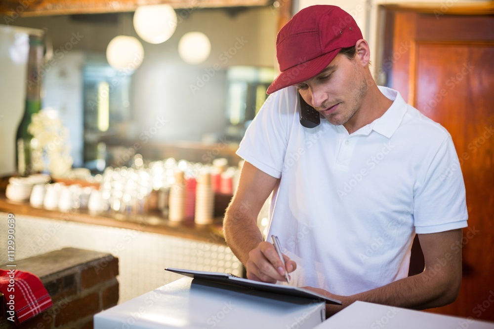 © WavebreakmediaMicro - Pizza delivery man taking an order over the phone © WavebreakmediaMicro - Pizza delivery man taking an order over the phone