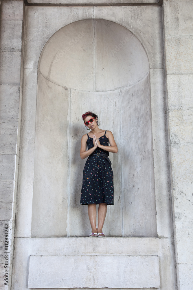 A woman standing in an apse and praying A woman standing in an apse and praying