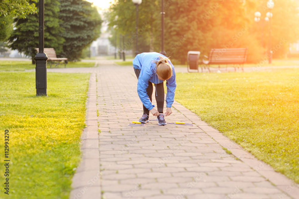 Woman runner tying laces before training. Marathon. Woman runner tying laces before training. Marathon.