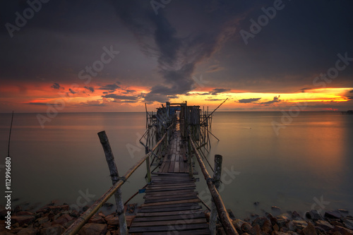 Long exposure image of "langgai" during beautiful sunset , the traditional fishing medium at Malaysia .Image has certain noise and soft focus when view at full resolution