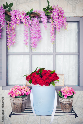 Image of beautiful and  colorful flowers in circular box and wooden pot