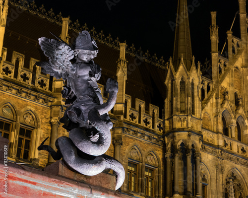 A statue of a putty in front of New Town Hall in Marienplatz, Munich, Germany photo