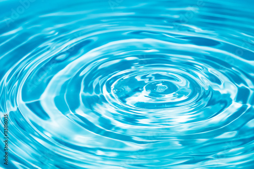 Blue water drop falling down. Abstract blue circle water drop ri