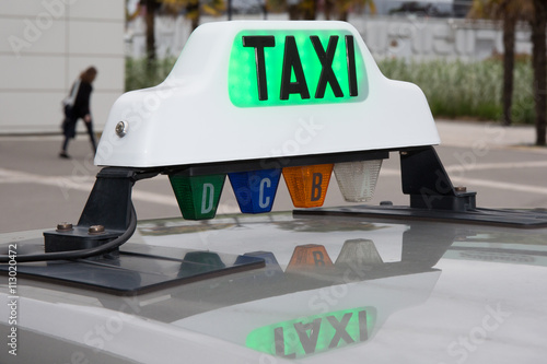 Green taxi sign in France on the car