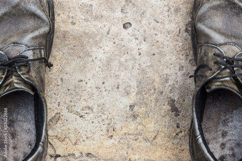 the old genuine leather shoes on concrete background
