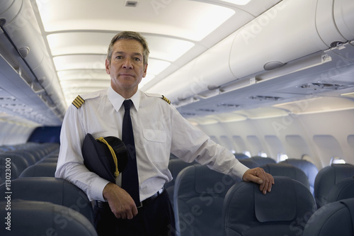 A pilot standing in the cabin of a plane