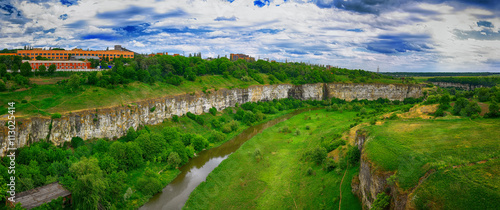 green summer hills in canyon of Dnister river in Ukraine with wh