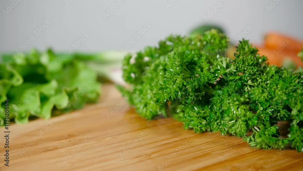 Fresh Parsley Falling On Wooden Cutting Board Fresh Parsley Falling On Wooden Cutting Board